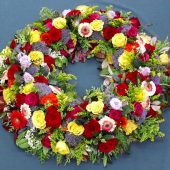 Rundgesteckter Trauerkranz mit Rosen und Gerbera